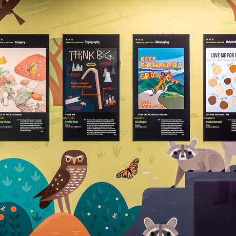 Winning Diversity x Design contest posters are on display at the California Academy of Sciences